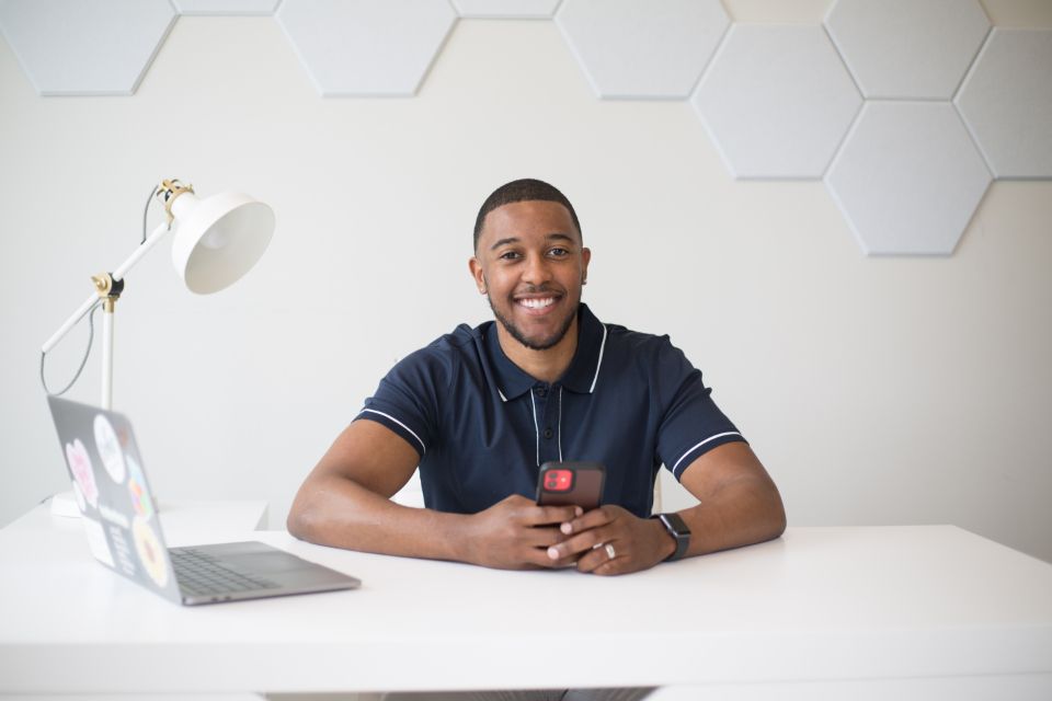Smiling business owner at his desk